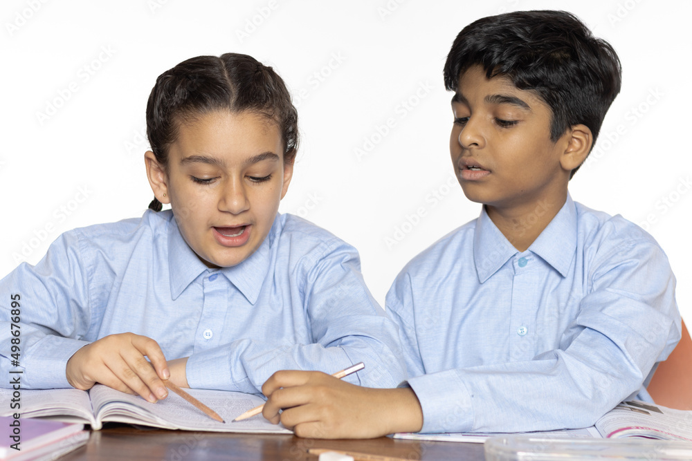 young girl and boy from primary school studying discussion learn in the classroom isolated on the white background young girl and boy from primary school studying discussion learn in the classroom isolated on the white background