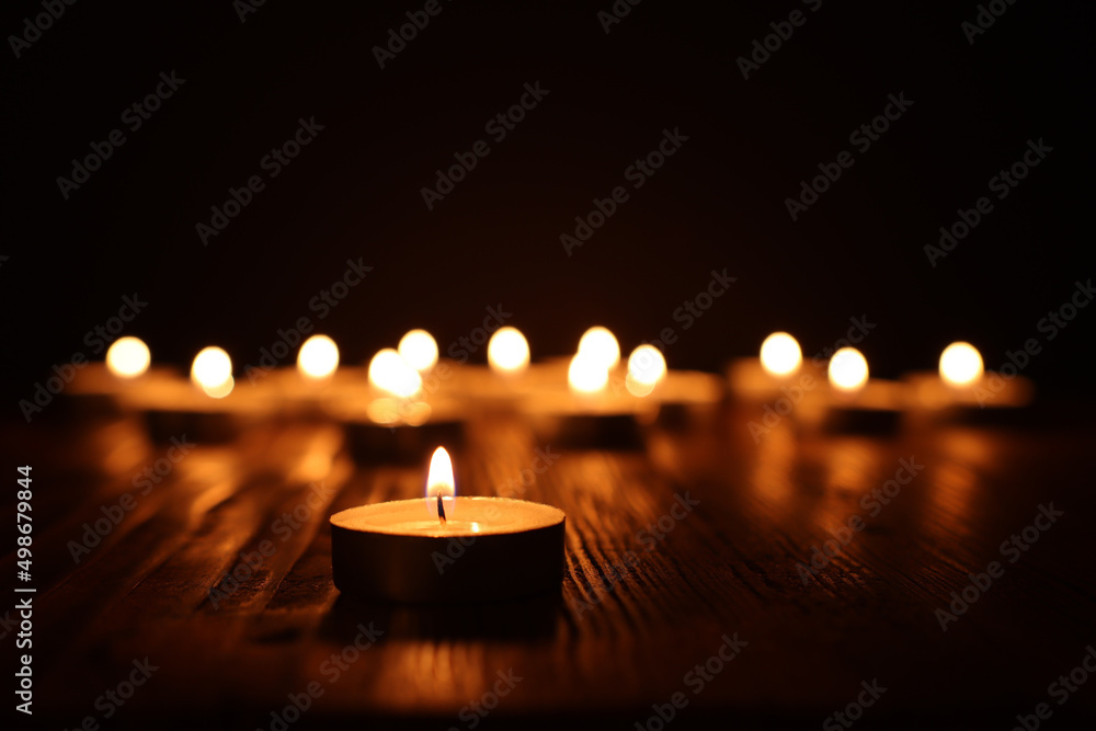 Burning candle over black background Burning candle over black background