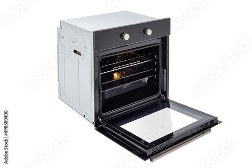 Black oven with open door and three trays, with two control knobs. with backlight on, at an angle of 45 degrees from above. Isolate on white