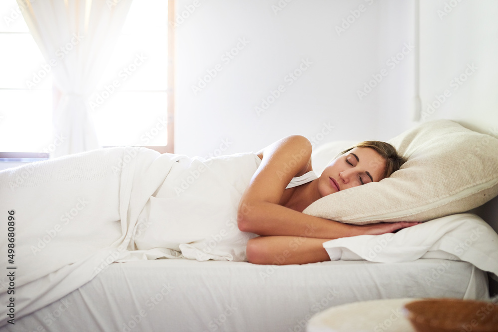 Saturdays are for sleeping in. Shot of a serene young woman sleeping in her bed at home. Saturdays are for sleeping in. Shot of a serene young woman sleeping in her bed at home.