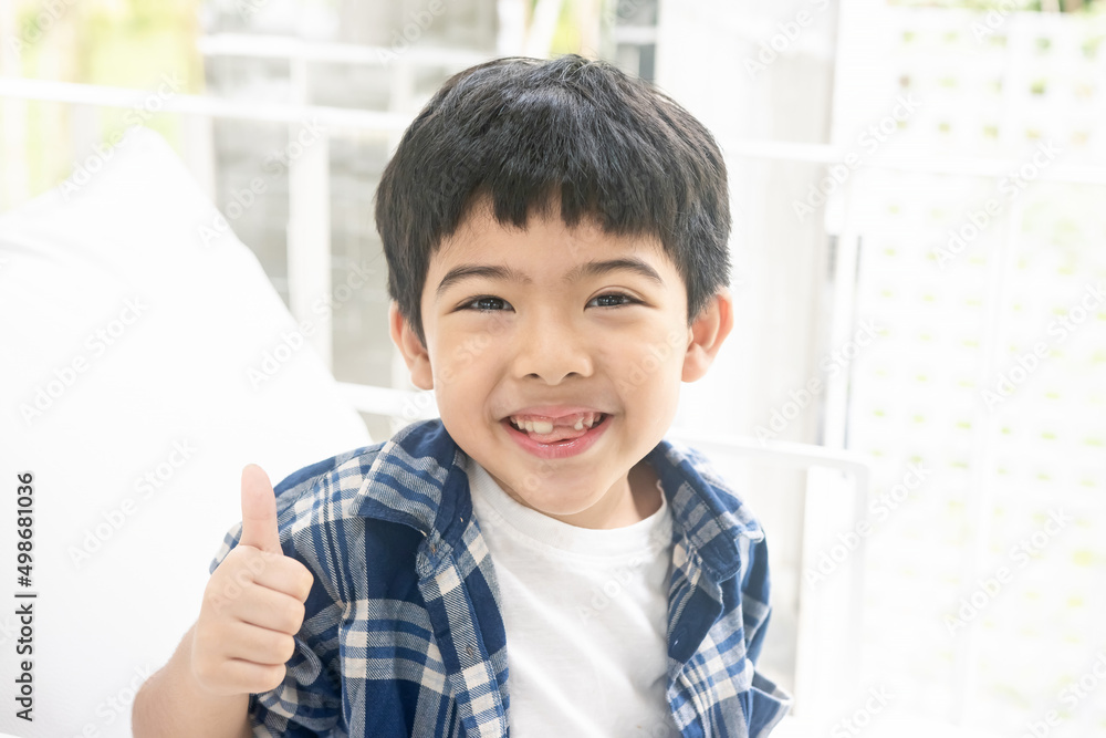 Portrait of happy boy showing thumbs up gesture, isolated over white background. Portrait of happy boy showing thumbs up gesture, isolated over white background.