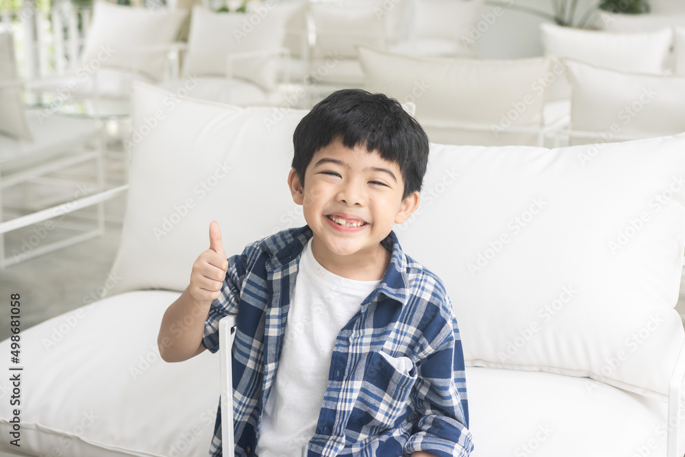 Portrait of happy boy showing thumbs up gesture, isolated over white background. Portrait of happy boy showing thumbs up gesture, isolated over white background.