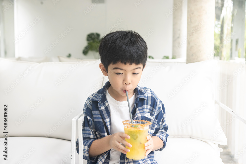 Cute little boy drinking juice at cafe. Cute little boy drinking juice at cafe.