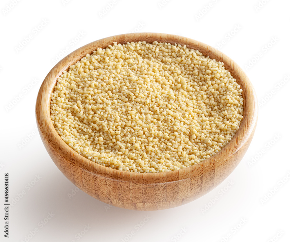 Uncooked dried cous cous in wooden bowl isolated on white background with clipping path Uncooked dried cous cous in wooden bowl isolated on white background with clipping path