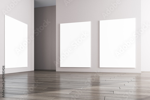 Modern concrete gallery interior with wooden flooring and blank white mock up frames on wall. Museum and exhibition hall concept. 3D Rendering.