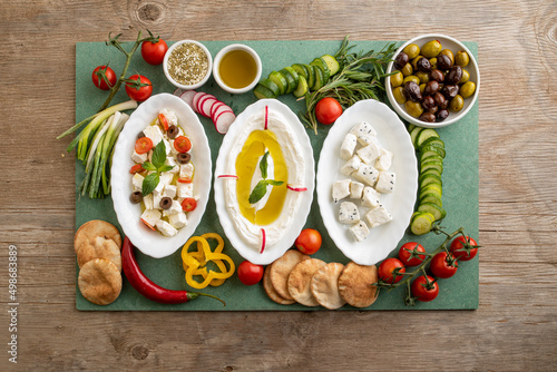 Closeup of Labneh, Greek cheese with veggies and Cheese with Fennel flower seeds and veggies; Lebanese food of Yougurt and cheese with veggies