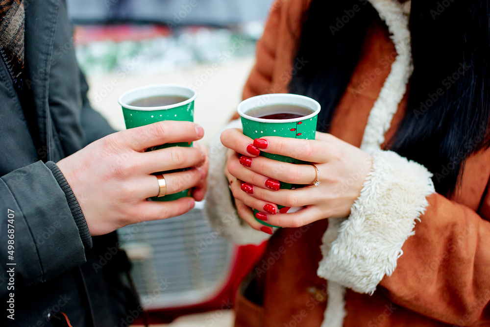 cups with hot tea in the hands of a couple cups with hot tea in the hands of a couple