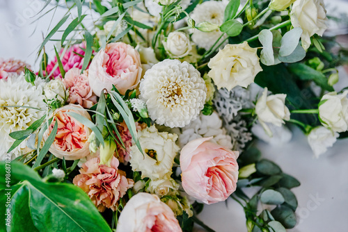 red floral arrangement in a vase of roses and carnations