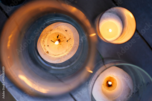 burning candles close-up in glass flasks © Oleg Kyslyi