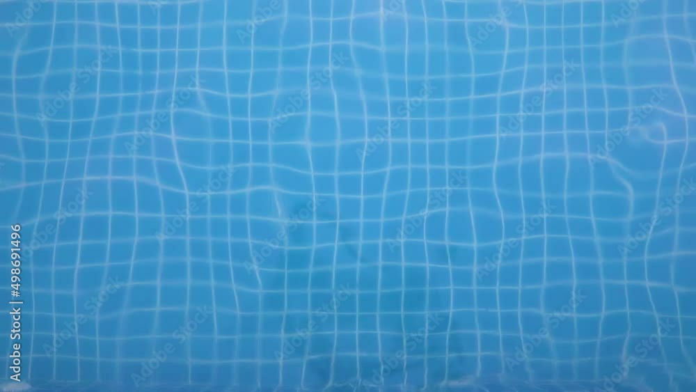 Wave patterns in swimming pool with blue transparent water. Background video footage for summer vacation holidays or spa. Caustic light effects. Wave patterns in swimming pool with blue transparent water. Background video footage for summer vacation holidays or spa. Caustic light effects.