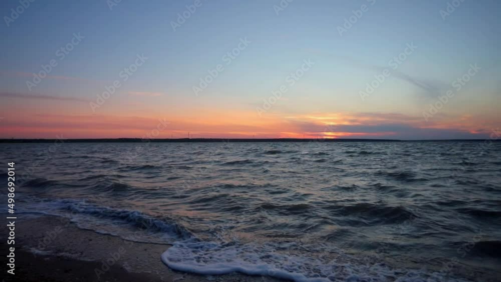 Dawn on a large lake, small waves and reflections on the surface of the water, surf Dawn on a large lake, small waves and reflections on the surface of the water, surf