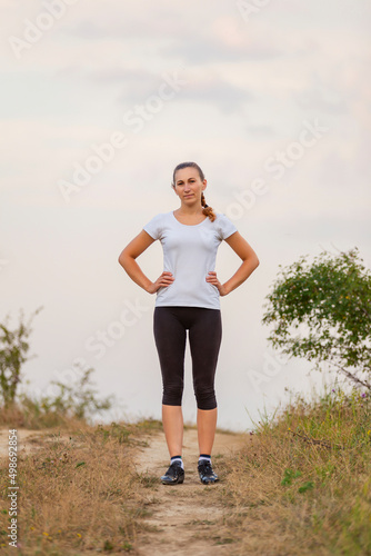 portrait of a woman running on a dirt road