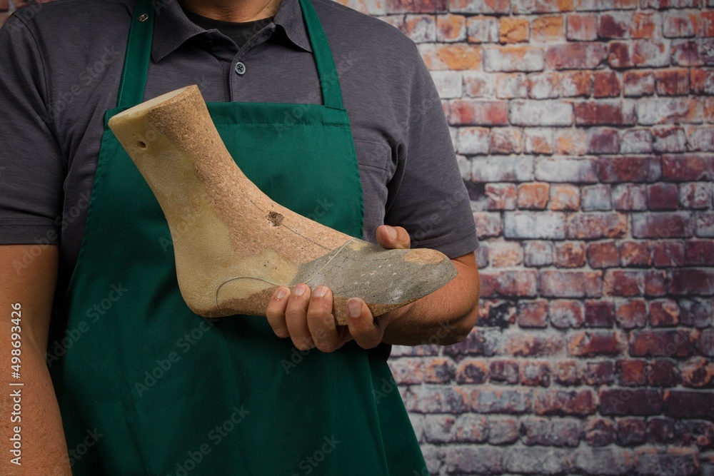 close up of hands of orthopedic shoemaker presenting an individual