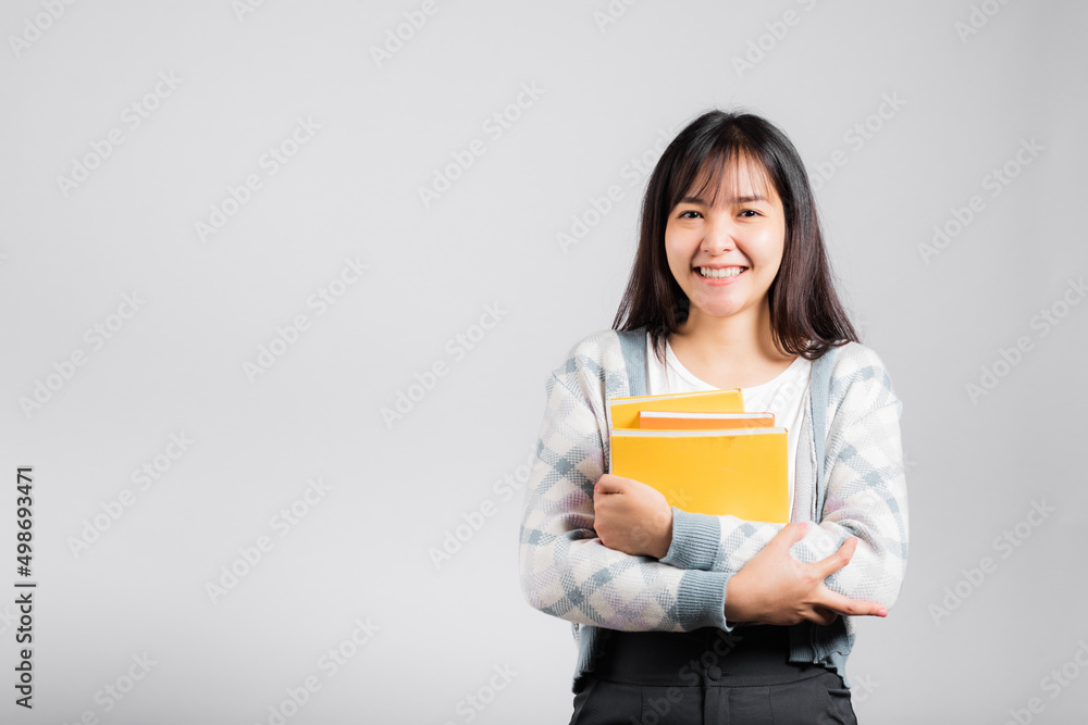 Woman teen smiling holding and hug embrace favorite book for lover, Portrait of beautiful Asian young female person teacher studio shot isolated on white background, education concept Woman teen smiling holding and hug embrace favorite book for lover, Portrait of beautiful Asian young female person teacher studio shot isolated on white background, education concept
