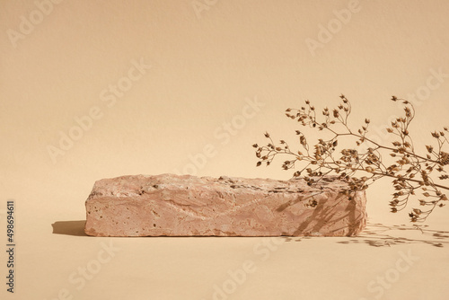 Stone Podium for promotion on beige Background. Natural pedestal. Stone podium floral shadow. Beauty product mockup. Scene to show products. Showcase, display case. Front View. Peach Fuzz photo