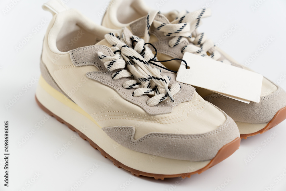 modern sneakers made of combined materials and colors with a high sole and  a label with copy space. fashion shoe boutique. online store. Stock Photo |  Adobe Stock