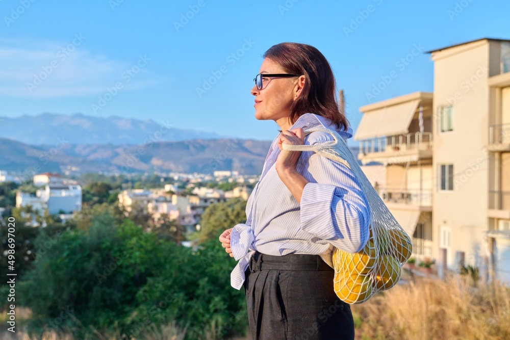 Happy calm woman enjoying vacation in nature, profile view