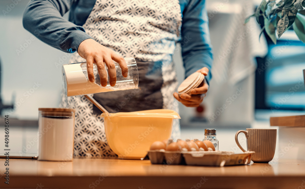 A man making dough in the kitchen at home. A man making dough in the kitchen at home.