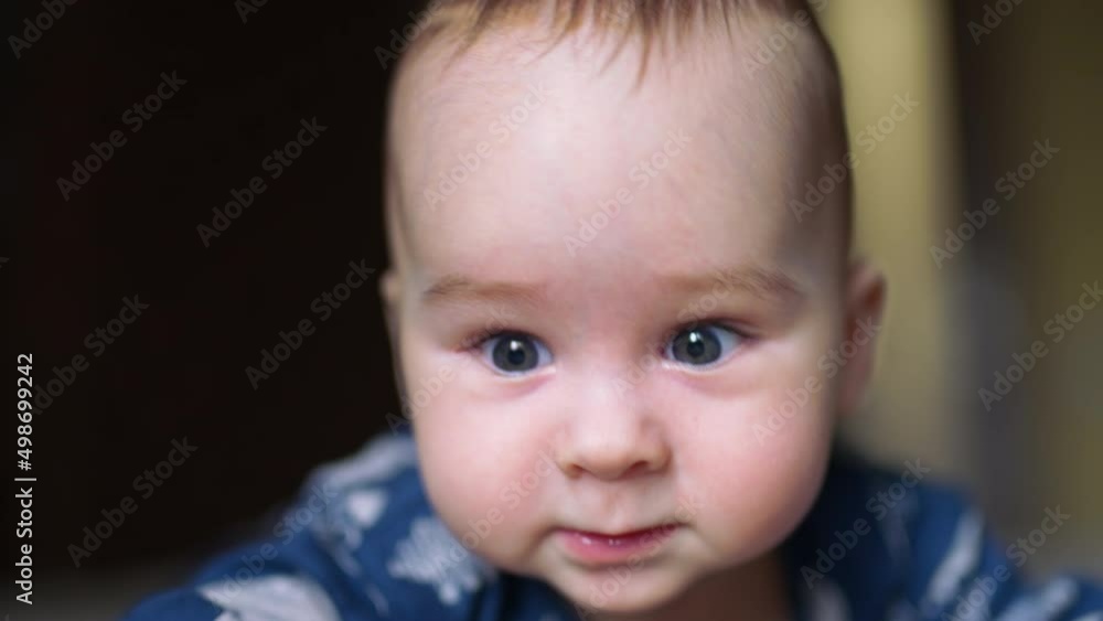Amazing cheerful smile from a Caucasian infant boy. Adorable cheerful resilient baby boy face close up. Amazing cheerful smile from a Caucasian infant boy. Adorable cheerful resilient baby boy face close up.