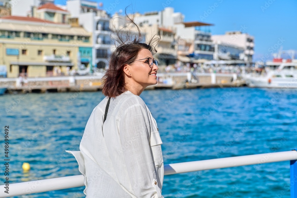 Summer sea walk of beautiful happy middle-aged woman