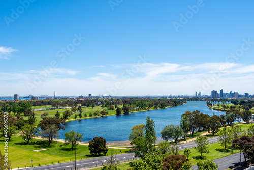 Melbourne cityscape with blue sky and river.
