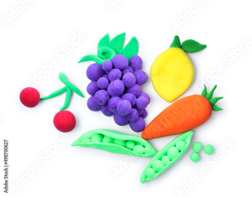 Fototapeta Naklejka Na Ścianę i Meble -  Different fruits and vegetables made from play dough on white background, top view