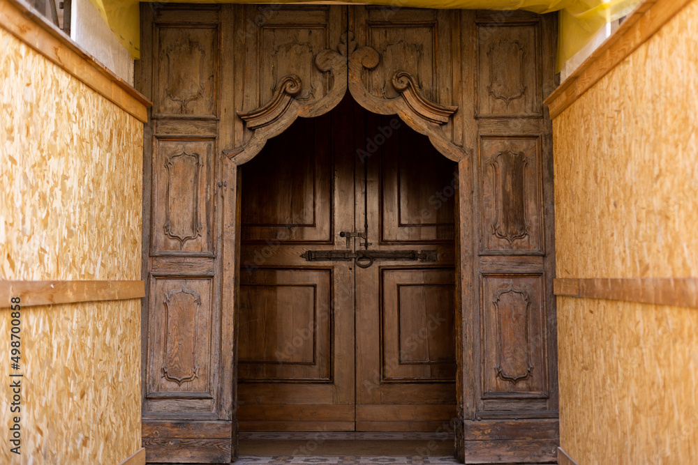 old wooden door at the construction site of an antique building