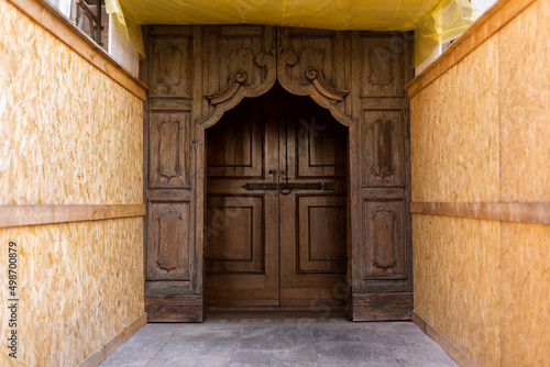 old wooden door at the construction site of an antique building © dyachenkopro