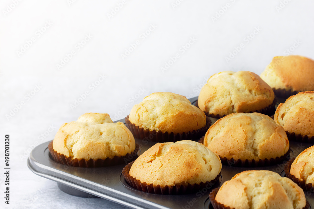 Delicious fresh homemade muffins in a baking tray. Tasty sweet breakfast, homemade cakes.