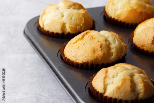 Delicious fresh homemade muffins in a baking tray. Tasty sweet breakfast, homemade cakes.