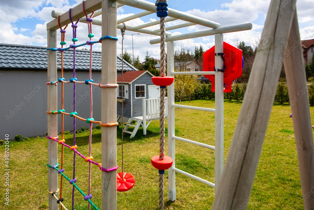 Garden playground for children with a climbing wall