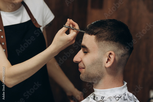 Close-up haircut with scissors. Barbershop