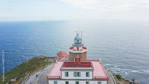 Finisterre lighthouse on Rocky cliff by the Atlantic Ocean, pilgrimage point, end of the old world. Spain photo