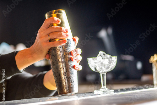 bartender beats cocktail in a shaker photo