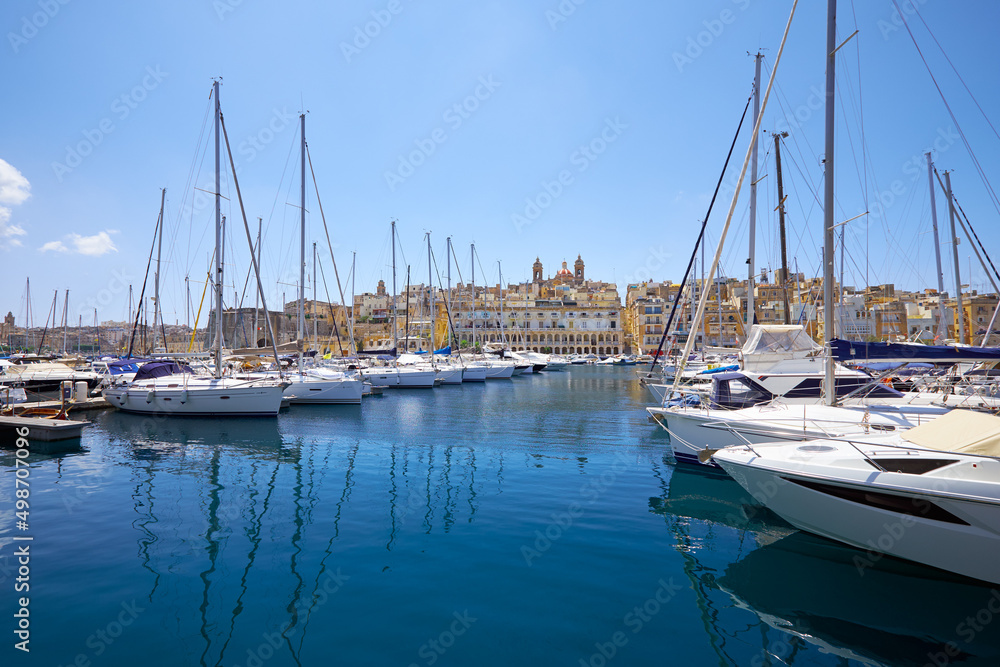 The view of yachts moored in harbor in Dockyard creek with Senglea peninsular on background. Malta