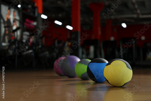 Medicine balls on floor in gym. Space for text