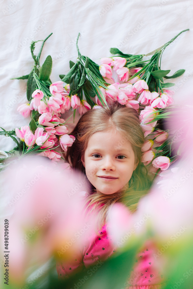 Portrait of a cute little girl with flowers in a pink dress. Girl lady in flowers. Mother's Day, top view. Spring portrait.
Portrait of a cute little girl with flowers in a pink dress. Girl lady in flowers. Mother's Day, top view. Spring portrait.