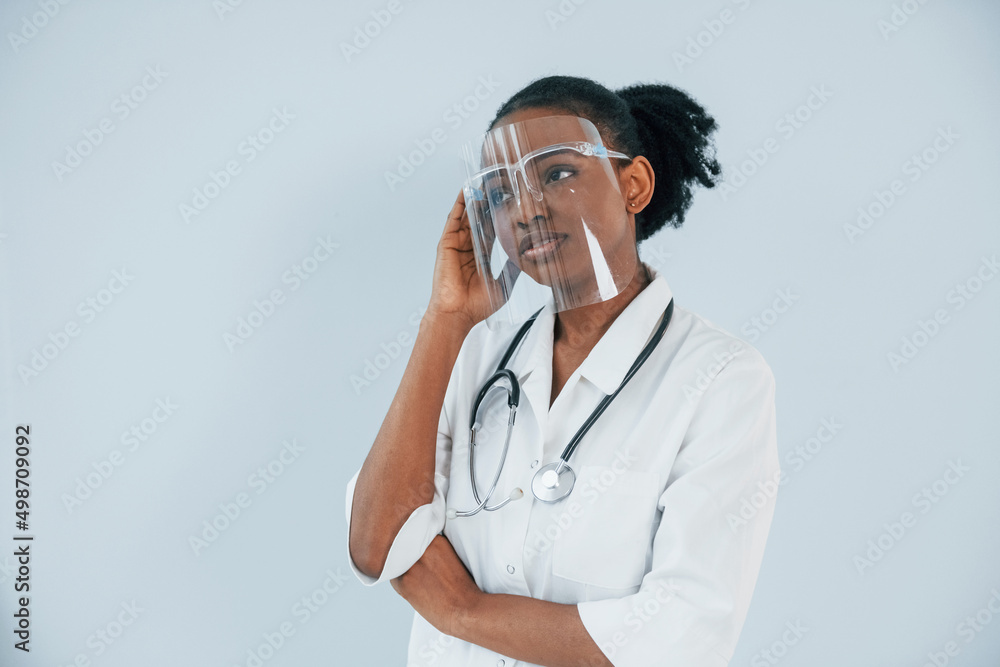 Medicine worker. Young african american woman is against white background