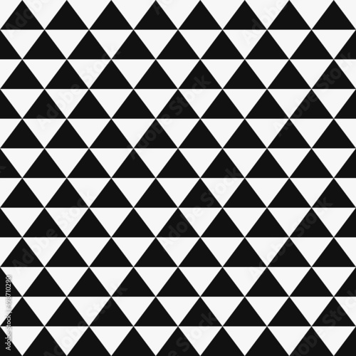 Black and white chess triangles. A vector of identical black triangles on a white canvas. Vector decor with triangles.