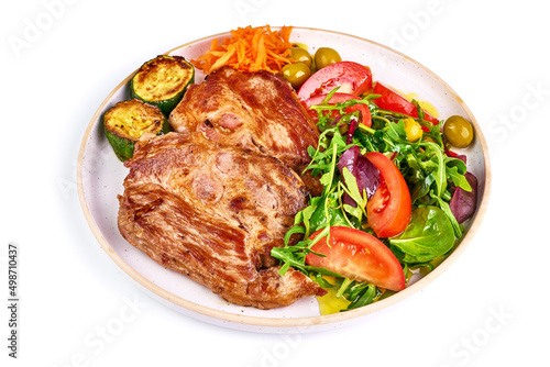 Grilled pork shoulder steak with vegetable salad, isolated on white background.
