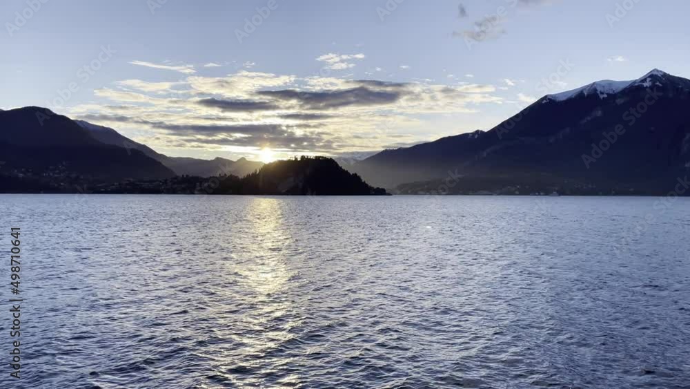 View on Como lake, sky with clouds and mountains at sunset. View on Como lake, sky with clouds and mountains at sunset.