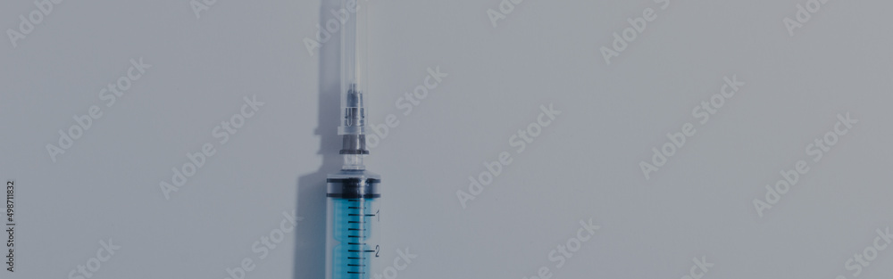 medical disposable plastic syringe for injection in the hospital, highlighted on a white background panoramic image medical disposable plastic syringe for injection in the hospital, highlighted on a white background panoramic image