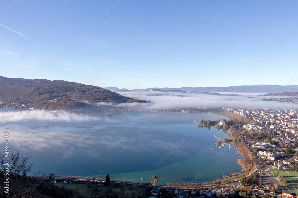 Sunrise above the deep misty valley and Annecy lake, early morning with fog above the lake and forest, the scenery and the landscape of the Annecy, France