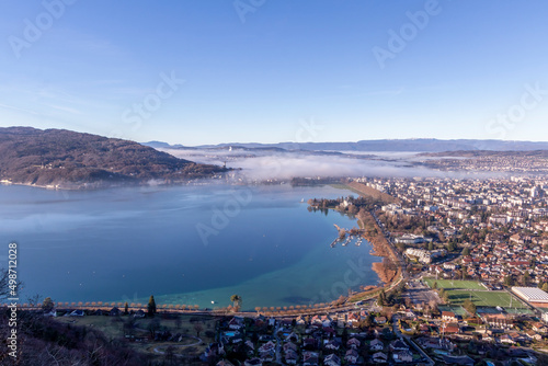 Aerial sunrise view of Annecy lake waterfront and old town with landmarks, France