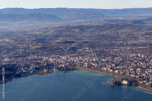 Aerial sunrise view of Annecy lake waterfront and old town with landmarks, France
