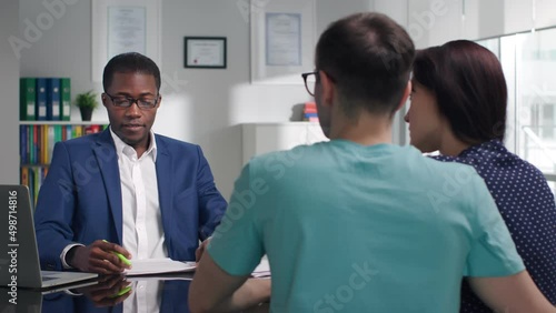 Civil servant advising young couple in modern office