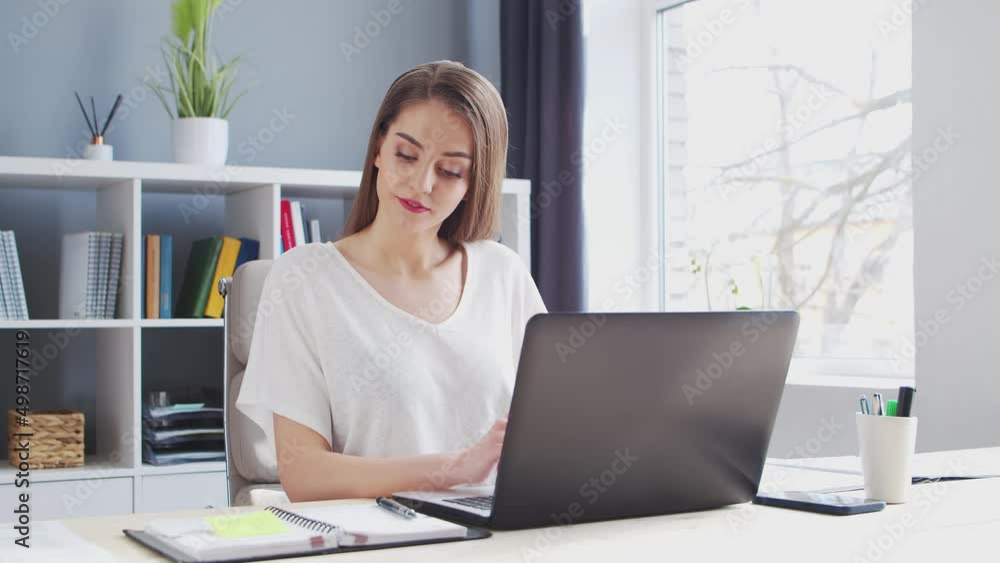 Young Woman Works at Home Office Using Computer. Workplace of Female Entrepreneur, Freelancer or Student. Remote Work and Education Concept. Young Woman Works at Home Office Using Computer. Workplace of Female Entrepreneur, Freelancer or Student. Remote Work and Education Concept.