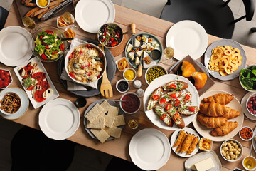 Brunch table setting with different delicious food indoors, top view