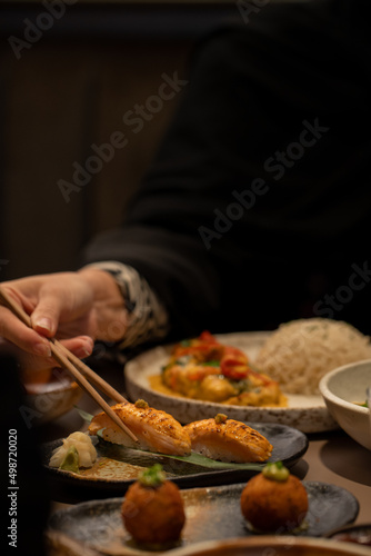 Sushi eating with a chopstick in hand