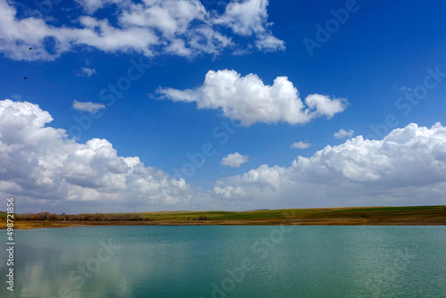 wonderful spring landscape of sky lake and clouds,clouds reflecting in water,